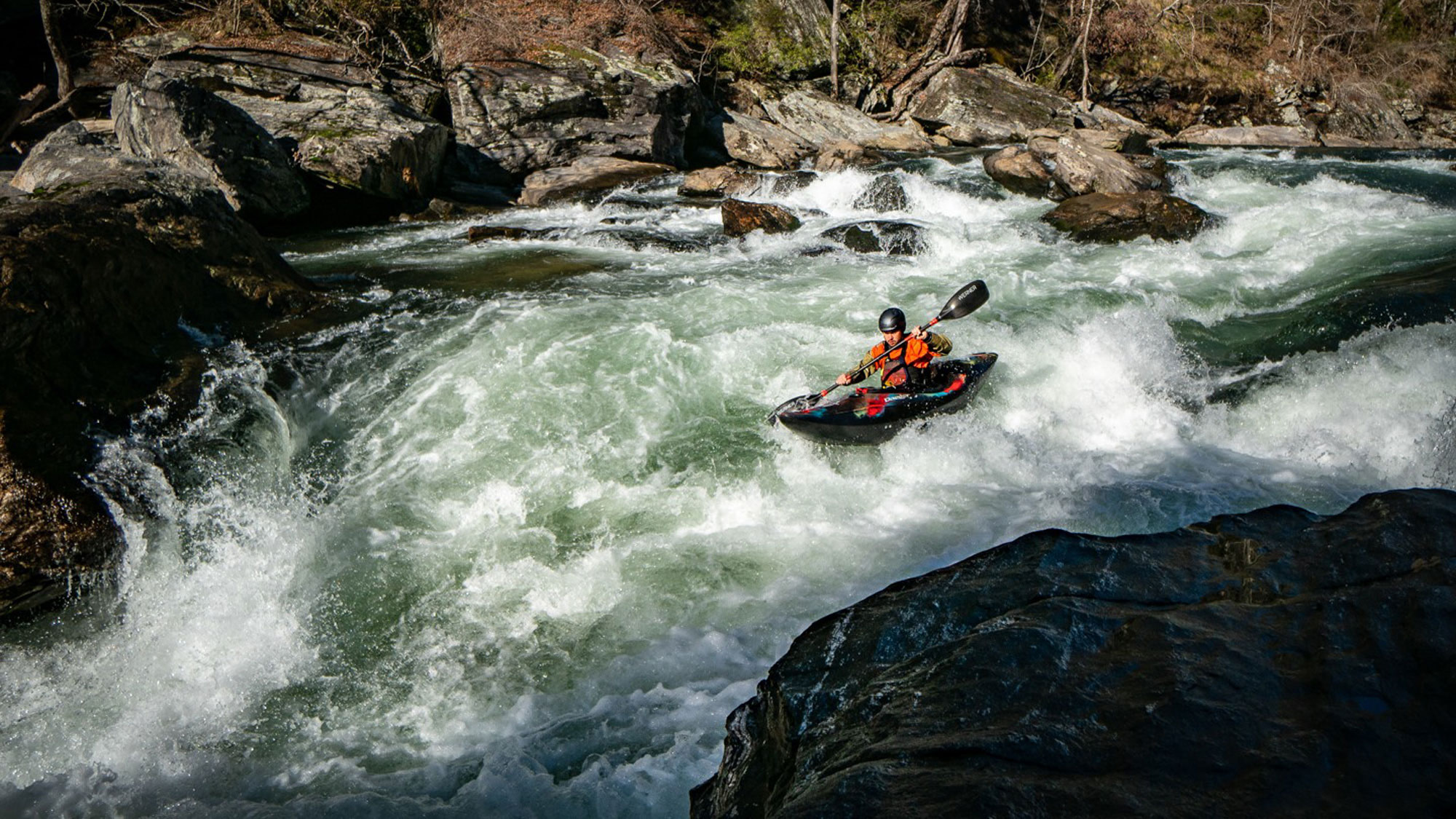 kayak shooting whitewater